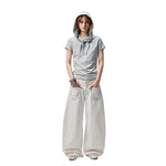 A pair of white, retro-style curved knife jeans with reverse embroidered detailing. The unique seam and leg shape are visible, highlighting the modern and edgy design.