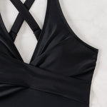 This high-waist swimsuit features a daring crossed design that sculpts and flatters your figure with slimming appeal.