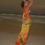 A backless strapless beach dress with a gradient floral pattern.