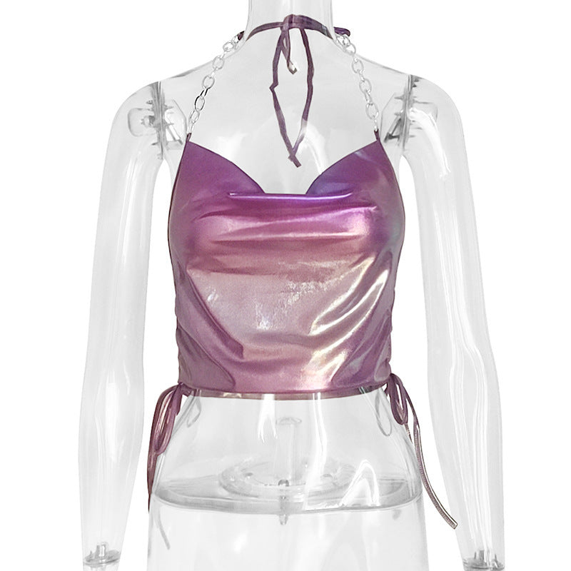 A person wearing a purple sleeveless halter top with a slim fit and backless design, suitable for street style.