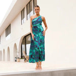 A model wearing a green, off-the-shoulder, sleeveless, pleated, one-shoulder maxi dress, suitable for business or elegant occasions.