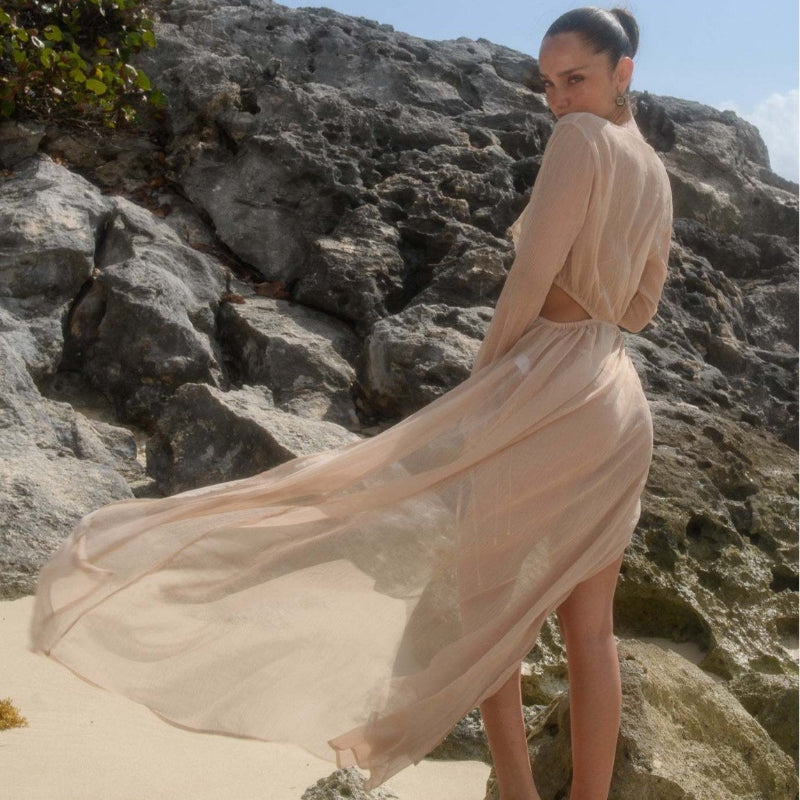 A long sleeve, solid-colored beach dress in a flowing, relaxed fit.