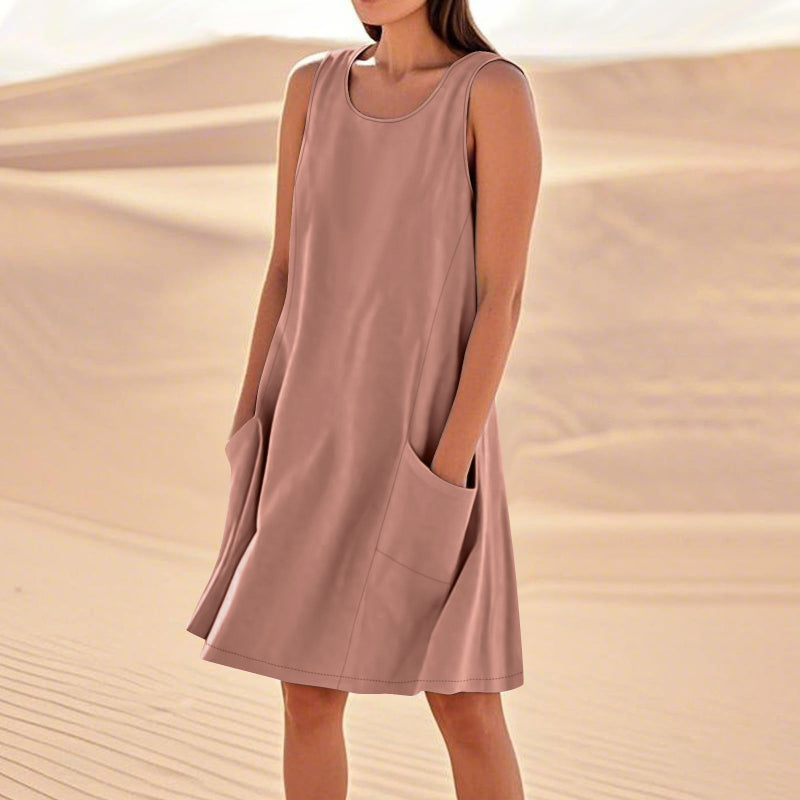 A sleeveless, mid-length A-line tank dress with a round neck.