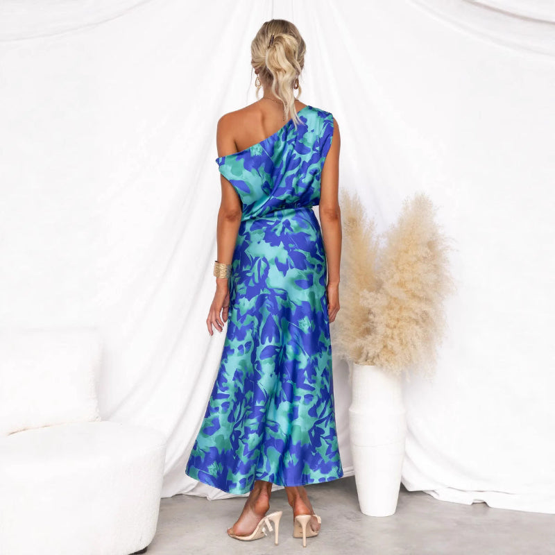 Model wearing a light blue split sleeveless printed midi dress with elegant flair in outdoor setting