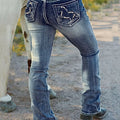 A pair of dark blue, high-waist, straight-leg denim jeans with subtle embroidery and a tie-dye gradient effect. The jeans are displayed flat, showcasing the style and texture.