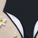 This daring one-piece swimsuit features a flattering high-waist design that enhances your silhouette with confidence and style.