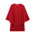 This short dress features a bold, loose cape design that makes a striking statement with effortless style.