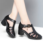 A pair of new style hollow sandals with a round toe and low heel, featuring a buckle closure and two-layer cowhide material.