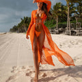 A long sleeve, solid-colored beach dress in a flowing, relaxed fit.