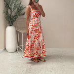 A model wearing a floral print colorblock strapless long dress with a one-shoulder design.