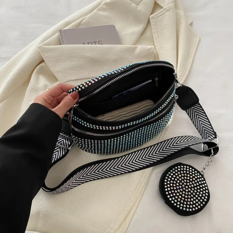 A medium-sized black crossbody bag made of PU material, adorned with metallic studs and featuring an adjustable strap.
