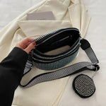 A medium-sized black crossbody bag made of PU material, adorned with metallic studs and featuring an adjustable strap.
