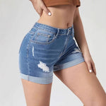 A pair of light blue, high-waisted denim shorts with distressed holes and a cuffed hem. The shorts have a skinny fit and are displayed on a flat surface.