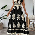 A stylish model wearing an elegant floral V-neck midi dress in a dark blue color. The dress has a waist-cinched design and a beautiful positional flower pattern, perfect for an elegant commuting style.