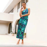 A model wearing a green, off-the-shoulder, sleeveless, pleated, one-shoulder maxi dress, suitable for business or elegant occasions.