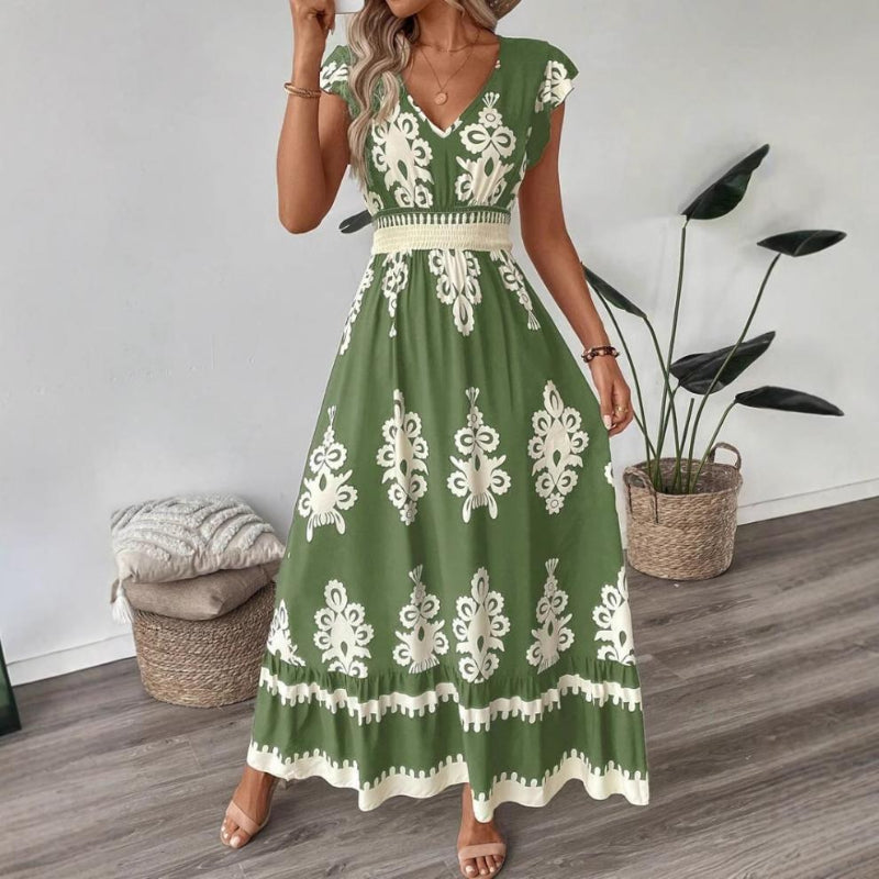 A stylish model wearing an elegant floral V-neck midi dress in a dark blue color. The dress has a waist-cinched design and a beautiful positional flower pattern, perfect for an elegant commuting style.