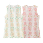 A sleeveless, short dress with a round neck, mid-waist fit, and a vibrant floral print.