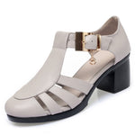 A pair of new style hollow sandals with a round toe and low heel, featuring a buckle closure and two-layer cowhide material.