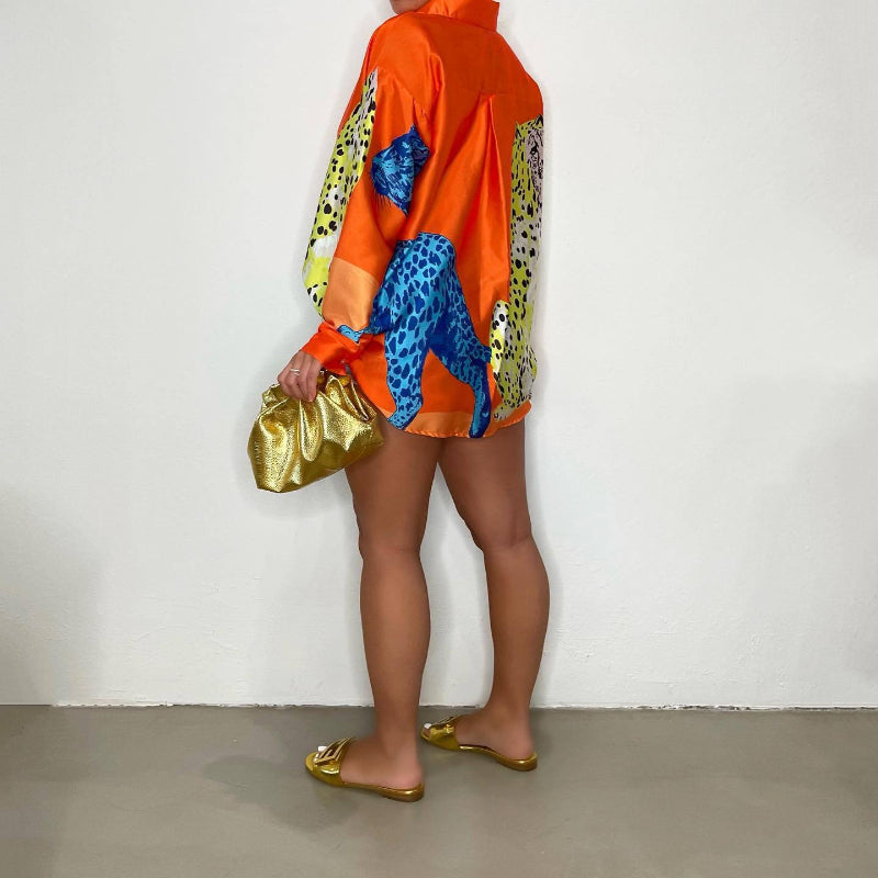 A loose-fit, long-sleeve shirt with a striking animal print pattern.