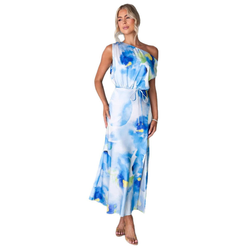 Model wearing a light blue split sleeveless printed midi dress with elegant flair in outdoor setting