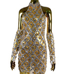 Gold and silver dress on a mannequin with a white background