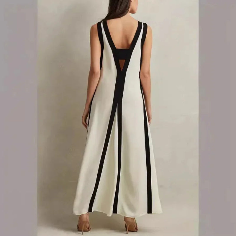 A backless A-line maxi dress in a black and white contrast color, with a V-neck.