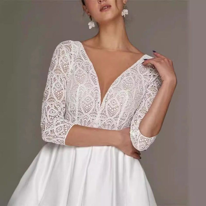 White lace wedding dress with a plain background