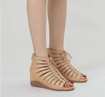 A pair of black high-top Roman sandals with a fish mouth toe style and lace-up closure.