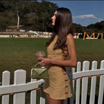 An elegant, sleeveless linen dress in a solid color with a stylish waist cut-out and a round neck.