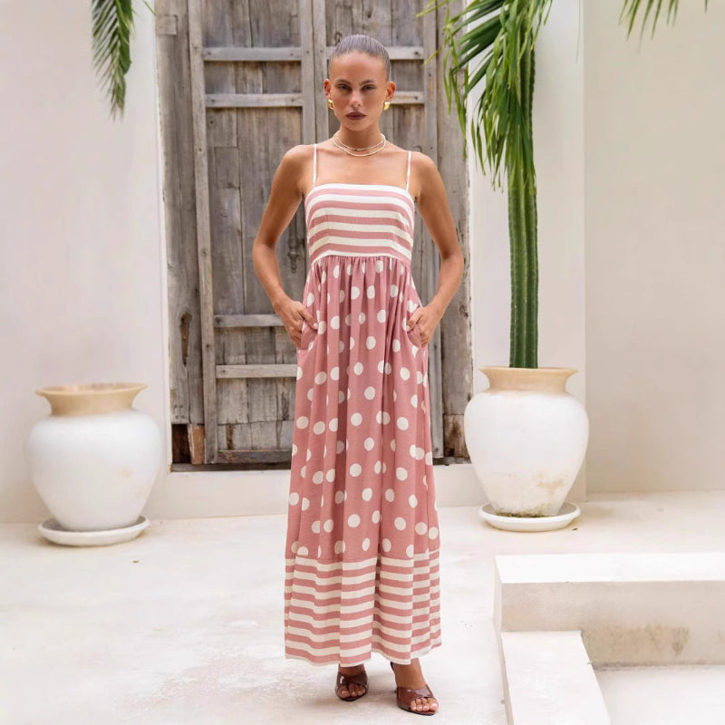 A sleeveless, high-waisted, midi-length dress with a printed pattern and a one-shoulder, backless design, photographed on a white background.