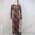 This daring mesh midi dress features a round neckline and long sleeves for a bold, stylish look.