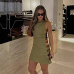 An elegant, sleeveless linen dress in a solid color with a stylish waist cut-out and a round neck.