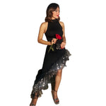 A full-length image of a woman wearing a black, sleeveless, mid-length dress with sequined lace detailing, a round neck, and an irregular hem.