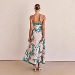 A model wearing a slim-fit, strapless, printed midi dress with a one-shoulder collar, suitable for casual wear.