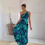 A model wearing a green, off-the-shoulder, sleeveless, pleated, one-shoulder maxi dress, suitable for business or elegant occasions.