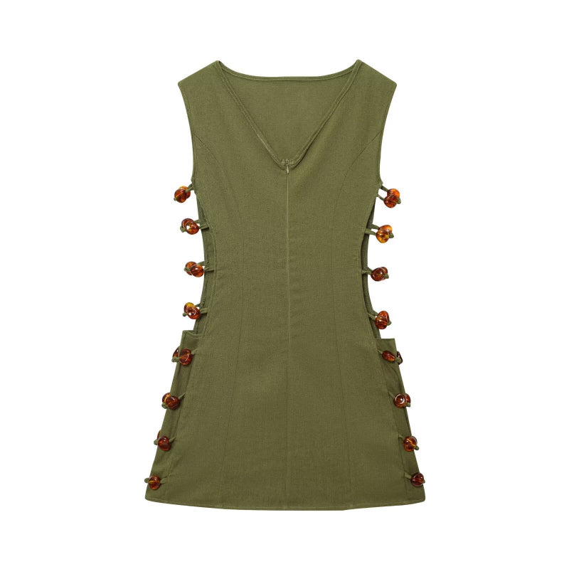 An elegant, sleeveless linen dress in a solid color with a stylish waist cut-out and a round neck.