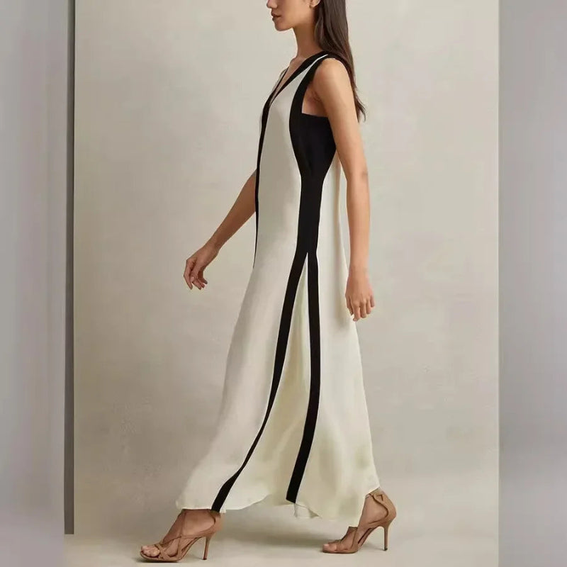 A backless A-line maxi dress in a black and white contrast color, with a V-neck.