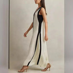 A backless A-line maxi dress in a black and white contrast color, with a V-neck.