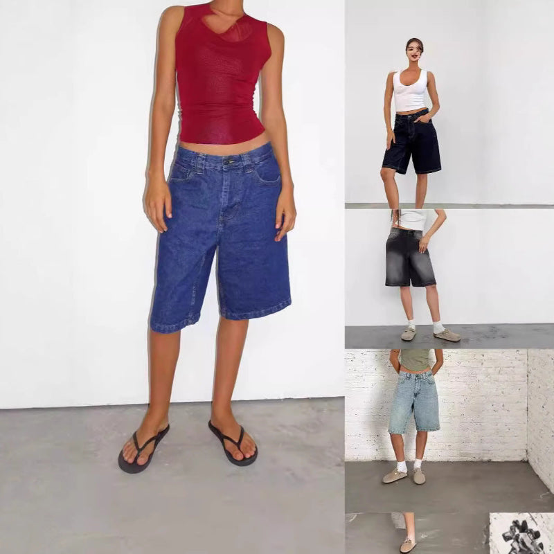 A pair of dark blue, mid-length, vintage-style denim shorts with a distressed finish. The shorts are laid flat, showcasing the straight-leg cut and medium-rise waist.