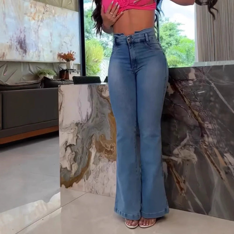 A model wearing slim fit, high-waisted, faded blue flared jeans with patchwork details.