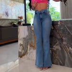 A model wearing slim fit, high-waisted, faded blue flared jeans with patchwork details.
