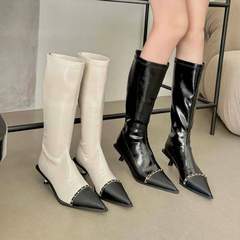A pair of elegant women's knee-high boots with a pointed toe and thin heel, shown in both black and apricot colors.