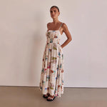 A model wearing a floral print, one-shoulder, sleeveless, A-line midi dress with a high waist, suitable for business or elegant events.