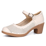 A pair of hollow sandals with a buckle closure, round toe, and low heel, showcasing the casual style and comfortable design.