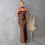 Model wears sleeveless blue hanging neck midi dress with elegant flow and high-fashion appeal