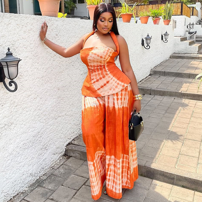 Backless printed long dress set with a halter neckline, a two-piece set for women, available in orange and navy blue.