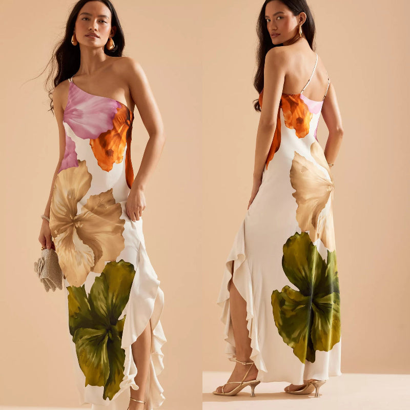 Woman wearing a slim-fit floral midi dress with asymmetric neckline and sleeveless design