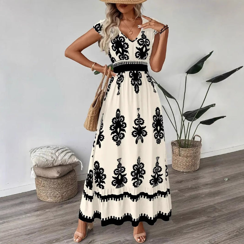 A stylish model wearing an elegant floral V-neck midi dress in a dark blue color. The dress has a waist-cinched design and a beautiful positional flower pattern, perfect for an elegant commuting style.