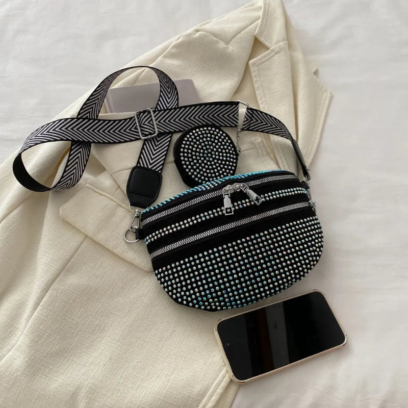 A medium-sized black crossbody bag made of PU material, adorned with metallic studs and featuring an adjustable strap.