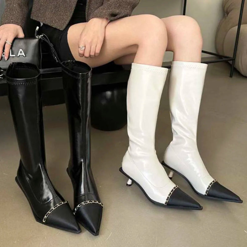 A pair of elegant women's knee-high boots with a pointed toe and thin heel, shown in both black and apricot colors.